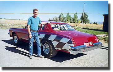 Rex Shobe next to his 1976 Oldsmobile